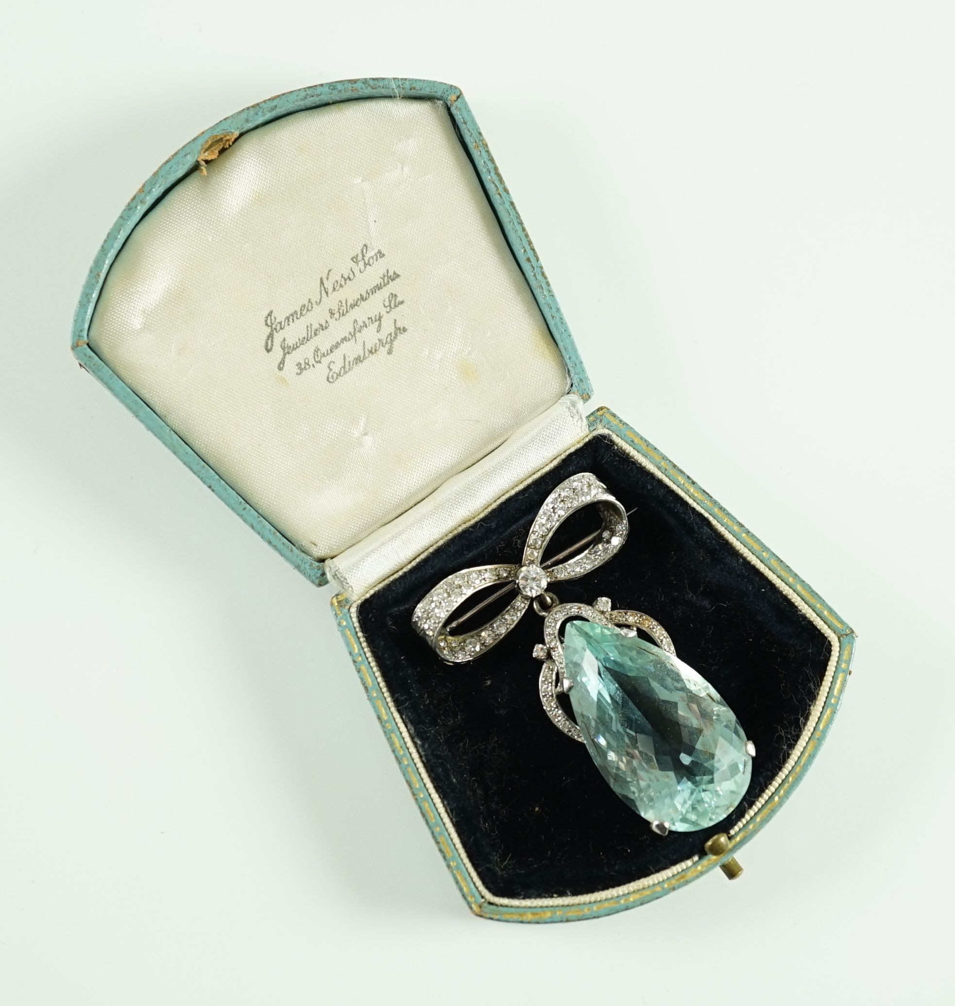 A mid 20th century continental white gold, facet cut pear shaped aquamarine and diamond set drop pendant, on a diamond set ribbon bow brooch